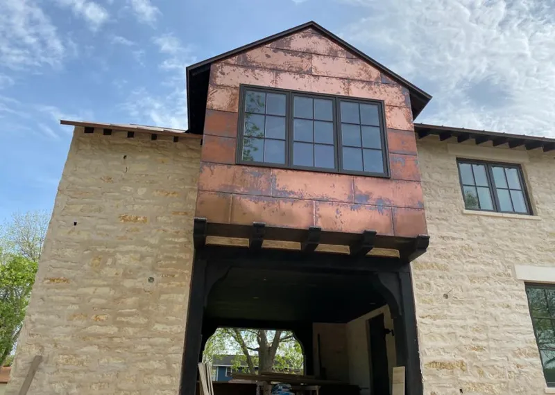 Copper metal panel facade on a stone building for Metal Roof Coating in Ozark